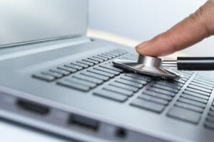 technician checking the health of laptop computer