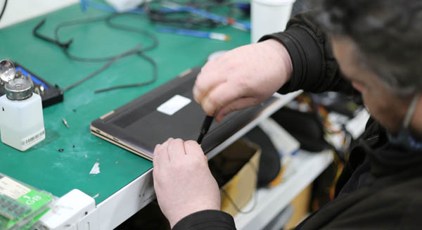 PC pitstop team member upgrading a hard drive on a laptop