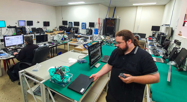 Technician finishing replacement laptop battery in Port Macquarie Computer Repair Shop