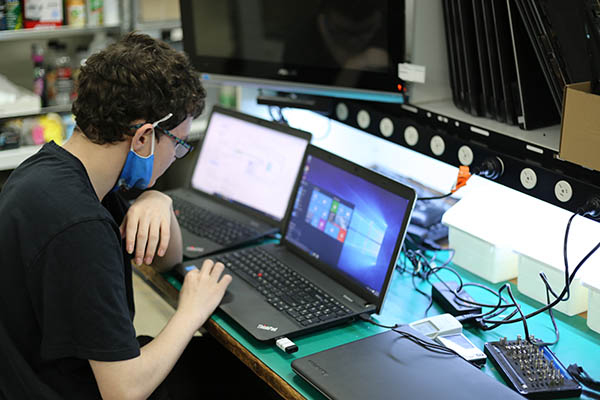 Computer Technician Checking Laptop Battery Replacement