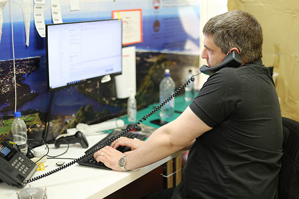 Computer Technician Helping Client with Phone Support