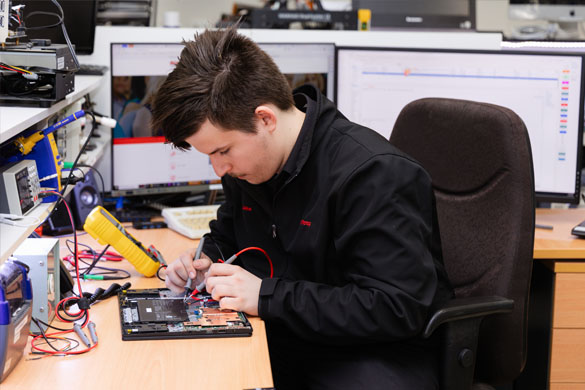 Technician replacing laptop screen